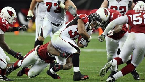 Falcons running back Michael Turner (33) finds little running room against the Cardinals defense during the NFC Wild Card game Saturday, Jan. 3, 2009, at University of Phoenix Stadium, Glendale, Ariz.   (Curtis Compton / Curtis.Compton@ajc.com)
