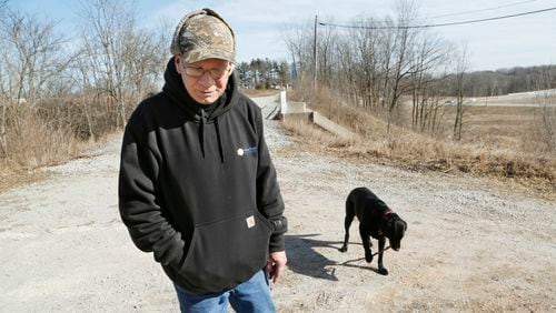 Brian Maas talks about hiking the trails with his dog Jessie near the Freedom Bridge Tuesday, Feb. 14, 2017, in Delphi, Ind. Maas, who is from Lafayette, said the area seemed safe and a good place to hike with his dog. Police announced that searchers around 12:15 p.m. Tuesday had found two bodies next to nearby Deer Creek. Police said foul play is suspected, however, they would not say whether the bodies were those of missing Delphi teens Liberty German and Abigail Williams, both 13. (John Terhune/Journal & Courier via AP)