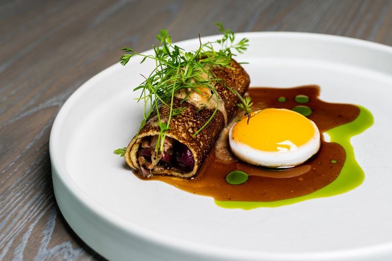 At Aix, a duck egg is served alongside the duck confit crepe. CONTRIBUTED BY HENRI HOLLIS