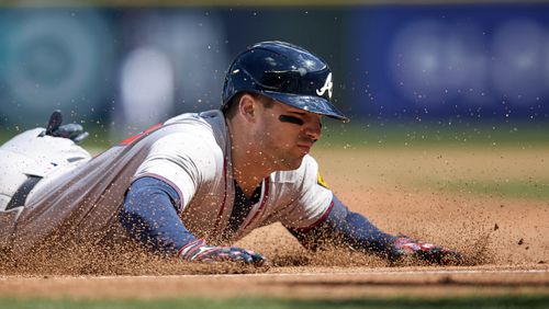 Atlanta Braves' Austin Riley slides into third on a two RBI triple against the Seattle Mariners during the fourth inning of a baseball game, Wednesday, May 1, 2024, in Seattle. (AP Photo/John Froschauer)