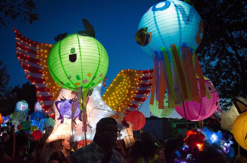 Homemade lanterns light up the night sky in every color imaginable as people gather together for the Atlanta Beltline Lantern Parade.