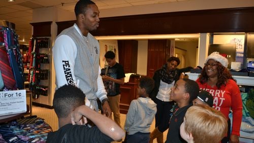 Dwight Howard speaks with kids from the Decatur YMCA after they complete a holiday shopping spree at JCPenney in Northlake Mall. COURTNEY MARTINEZ/COURTNEY.MARTINEZ@COXINC.COM