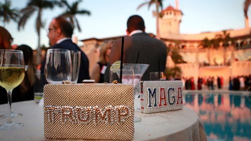 "Trump" and "MAGA" purses sit on a poolside table as guests gather before the start of the Republican Party of Palm Beach County's Lincoln Day Dinner at Mar-a-Lago in Palm Beach, Florida on Friday, March 16, 2018. (Bruce R. Bennett/The Palm Beach Post/TNS)