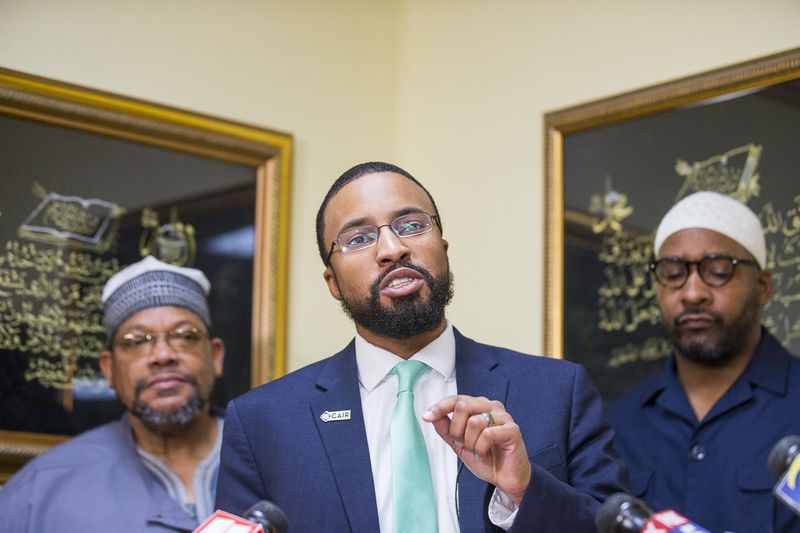 Executive director of CAIR Georgia, Edward Ahmed Mitchell, (center) speaks during a press conference at the Masjid Al-Mu'minun mosque in Atlanta's Peoplestown neighborhood, Friday, March 15, 2019. 