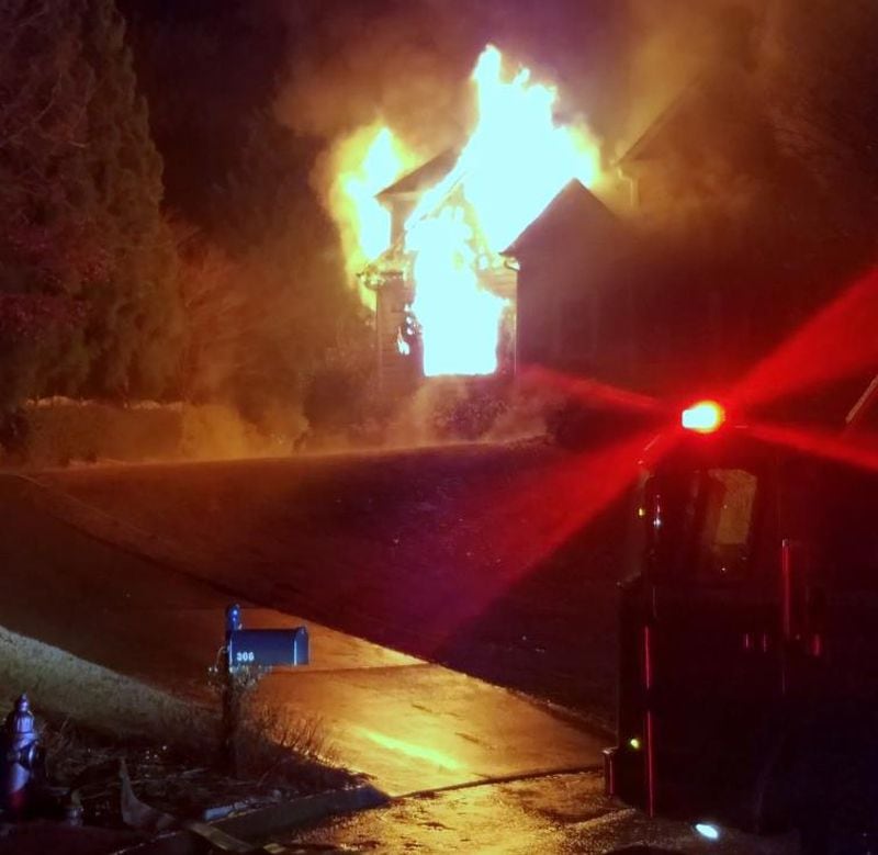 An overnight fire destroyed a two-story home in Cherokee County while its residents were out of town on vacation, authorities said. Lightning sparked the blaze, according to investigators.