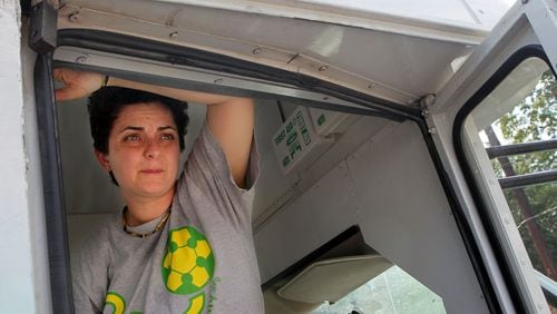 Luma Mufleh watches her students from inside the team bus before soccer practice in Clarkston in September 2012. AJC FILE PHOTO