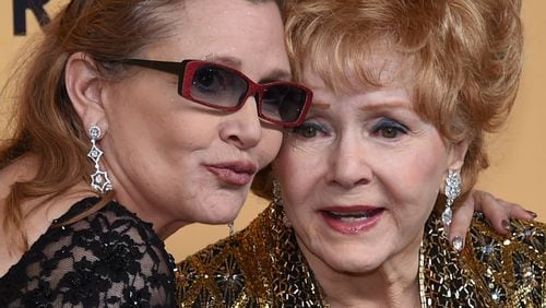 Actresses Debbie Reynolds (R), recipient of the Screen Actors Guild Life Achievement Award, and her daughter Carrie Fisher pose in the press room during the 21st Annual Screen Actors Guild Awards at The Shrine Auditorium on January 25, 2015 in Los Angeles, California. (Photo by Ethan Miller/Getty Images)