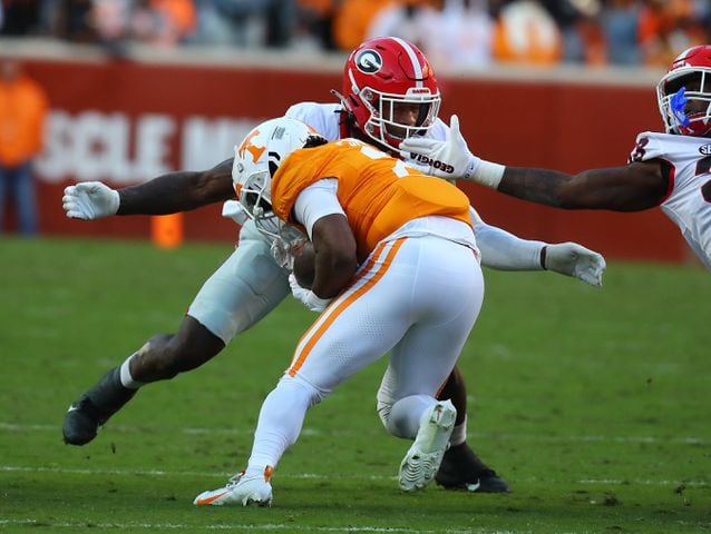 Georgia linebacker Smael Mondon Jr. tackles Tennessee running back Jabari Small during the first half in a NCAA college football game on Saturday, Nov. 18, 2023, in Knoxville.  Curtis Compton for the Atlanta Journal Constitution