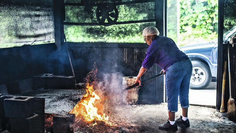 Helen Turner stokes the coals in her Tennessee smokehouse, as seen in Matt Moore’s new book “The South’s Best Butts.” (Courtesy of Time Inc. Books / Andrea Behrends)