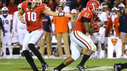 November 12, 2016, Athens: Jacob Eason hands off to Nick Chubb during the fourth quarter against Auburn in an NCAA college football game on Saturday, Nov. 12, 2016, in Athens. Curtis Compton/ccompton@ajc.com