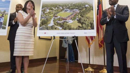 Mayor Kasim Reed and Atlanta Parks and Recreation Commissioner Amy Phuong, left, applaud after revealing renderings of new Grant Park Gateway Project, a 1,000-space parking garage, greenspace and restaurant on Tuesday.
