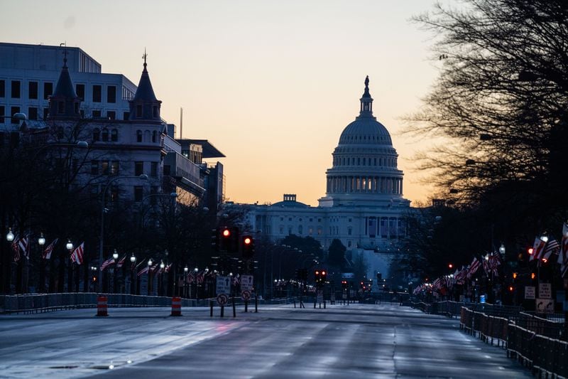 The sun rises behind the U.S. Capitol Building, seen from Pennsylvania Avenue in Washington, D.C. (Kent Nishimura/Los Angeles Times/TNS)
