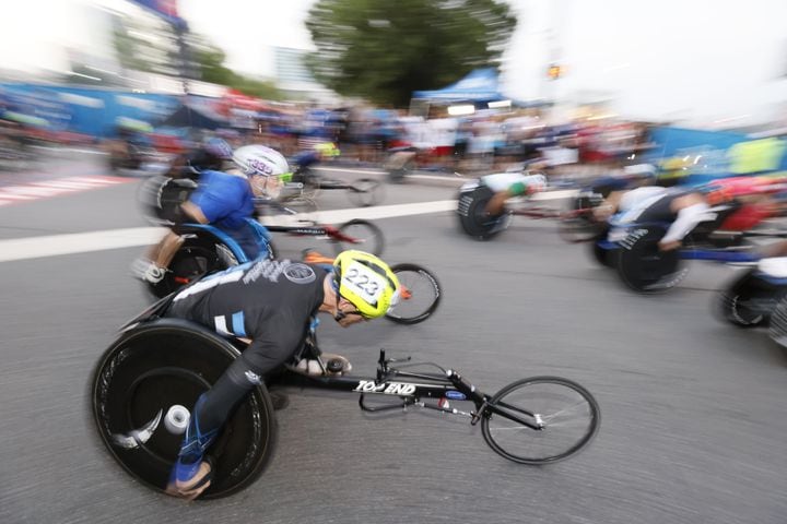 Men's wheelchair division racers streak down Peachtree street during the 53rd running of the Atlanta Journal-Constitution Peachtree Road Race in Atlanta on Sunday, July 3, 2022. (Miguel Martinez / Miguel.Martinezjimenez@ajc.com)