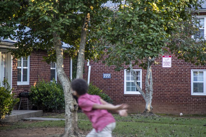 A child plays outside at Trestletree Village Apartments in Atlanta’s Grant Park neighborhood. (Alyssa Pointer/ AJC)