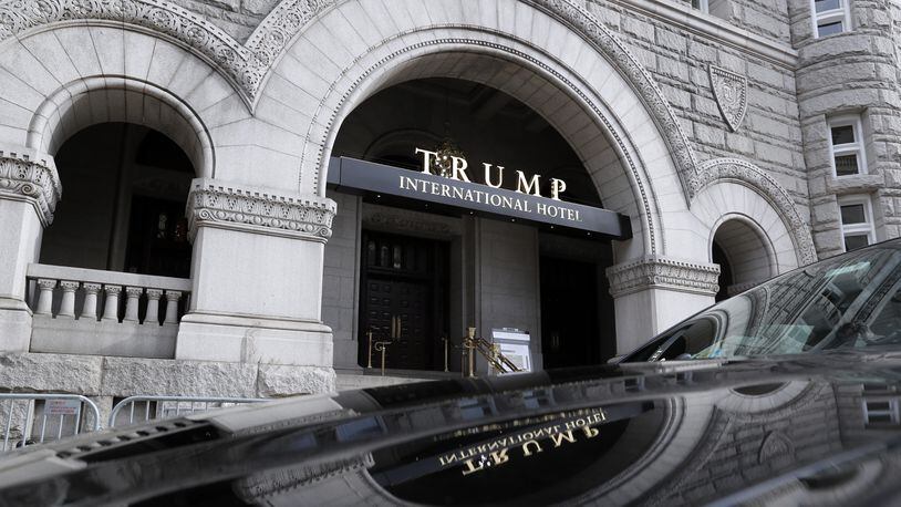 In this photo taken Dec. 21, 2016, the Trump International Hotel in Washington. Trump's $200 million hotel inside the federally owned Old Post Office building has become the place to see, be seen, drink, network, even live, for the still-emerging Trump set. It's a rich environment for lobbyists and anyone hoping to rub elbows with Trump-related politicos, despite the veil of ethics questions that hangs overhead. (AP Photo/Alex Brandon)