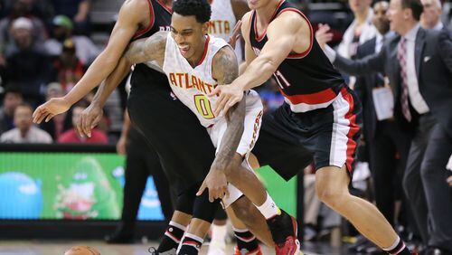 ATLANTA: Hawks guard Jeff Teague is fouled by Trial Blazers defenders Tim Frazier (left) and Meyers Leonard during a basketball game on Monday, Dec. 21, 2015, in Atlanta. The Hawks beat the Trail Blazers 106-97. Curtis Compton / ccompton@ajc.com