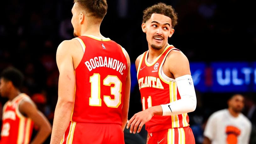 Hawks guard Trae Young (11) and guard Bogdan Bogdanovic are eager to get back on the court. (AP Photo/Jessie Alcheh)