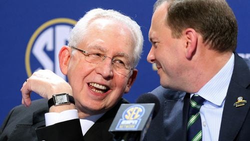 SEC Commissioner Mike Slive, left, speaks with SEC Network President Justin Connolly during a news conference the day before the SEC Championship game at the Georgia Dome in Atlanta, December 6, 2013. JASON GETZ / JGETZ@AJC.COM