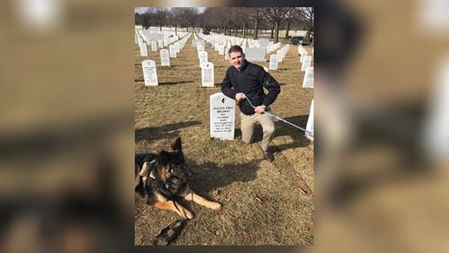 E-4 Specialist Winston Hencely at the grave of Sgt. Allan Brown, who died from injuries suffered in the November 12, 2016 suicide bombing attack in Afghanistan that left Hencely disabled.