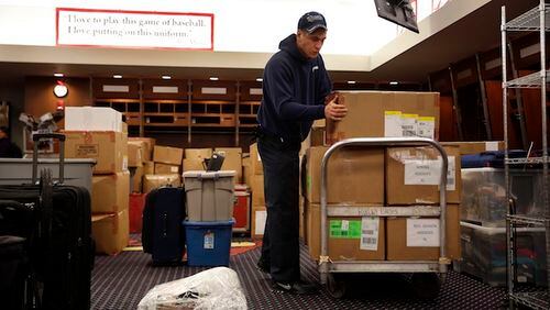 Dustin Heddy with United Van Lines packs up gear in the St. Louis Cardinals clubhouse to be sent to the baseball team's spring training facility Thursday, Feb. 11, 2016, in St. Louis. Cardinals pitchers and catchers are scheduled to report to camp on Feb. 17, 2016, in Jupiter, Fla. (AP Photo/Jeff Roberson)