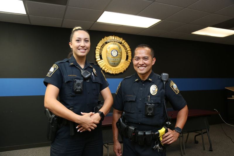 Officers Andrea Serrano (left) and Travis Nguyen did not know they were arresting a former rapper and reality star when they took Raymond “Benzino” Scott into custody on June 22. (Tyson Horne/tyson.horne@ajc.com)