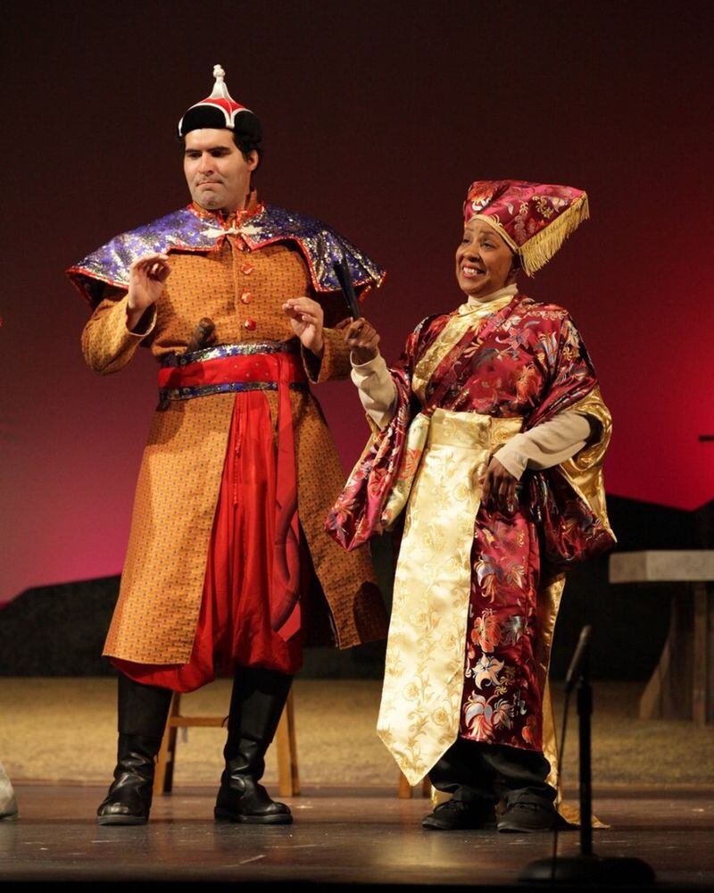 Cristian Gonzalez portrays General Mahzuno and Brenda Porter stars as Rhonda Charles in Topher Payne’s “Greetings Friend Your Kind Assistance Is Required,” a world premiere at Georgia Ensemble Theatre in Roswell. CONTRIBUTED BY DAN CARMODY / STUDIO 7
