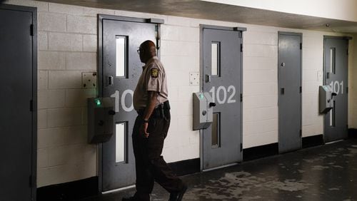 A corrections officer looks in a jail cell during a tour of the Fulton County Jail on Monday, December 9, 2019, in Atlanta. (Elijah Nouvelage/Special to the Atlanta Journal-Constitution)
