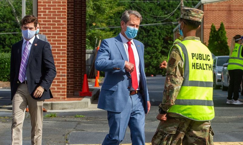 Governor Brian Kemp talks with a member of the National Guard after touring a COVID 19 testing site at the Lilburn First Baptist Church June 26, 2020. STEVE SCHAEFER FOR THE ATLANTA JOURNAL-CONSTITUTION