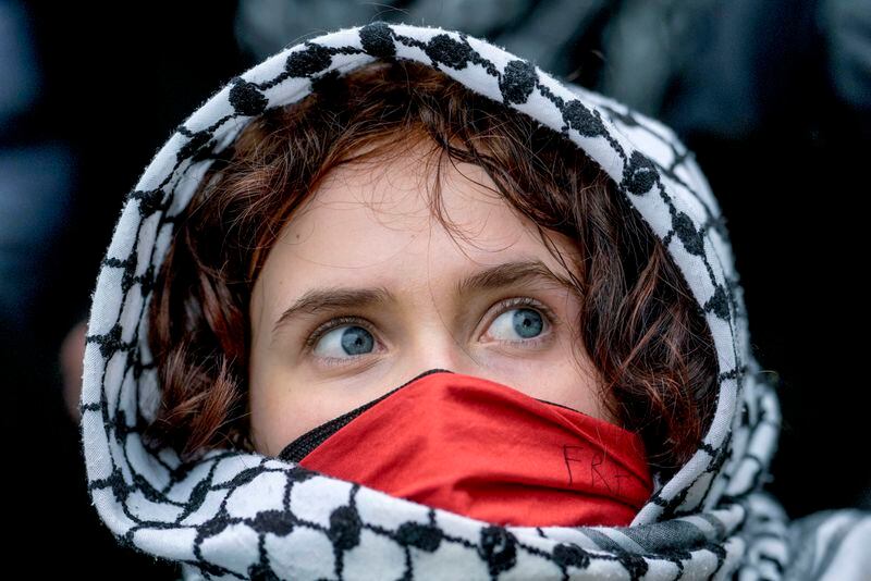 A young woman looks on during a pro-Palestinians demonstration by the group "Student Coalition Berlin" in the theater courtyard of the 'Freie Universität Berlin' university in Berlin, Germany, Tuesday, May 7, 2024. Pro-Palestinian activists occupied a courtyard of the Free University in Berlin on Tuesday. (AP Photo/Markus Schreiber)