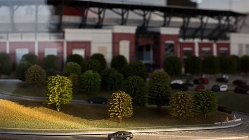 A model car sits alone on a road surrounding a scale model of the new Braves stadium at the SunTrust Park Preview Center. BRANDEN CAMP/SPECIAL