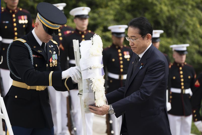 Japan's Prime Minister Fumio Kishida, lays a wreath at the Tomb of the Unknown Soldier, at Arlington National Cemetery, in Arlington, Va., Tuesday, April 9, 2024. (AP Photo/Manuel Balce Ceneta)