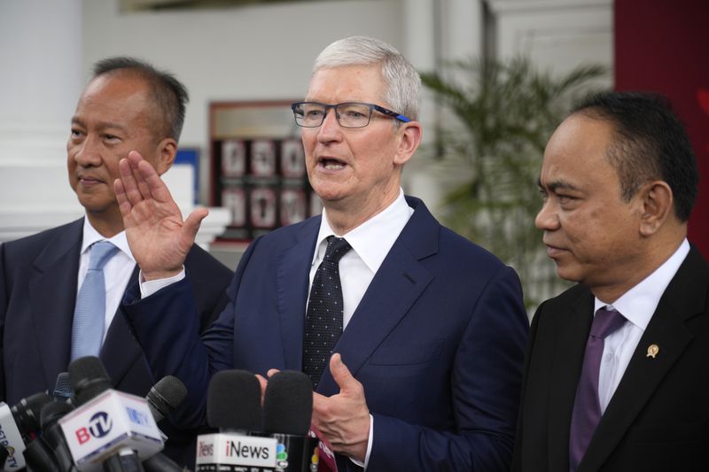 Apple CEO Tim Cook ,center, talks to journalist during a joint press conference with Indonesian Minister of Industry Agus Gumiwang Kartasasmita, left, and Indonesian Minister of Communication and Information Technology Budi Arie Setiadi, right, after a meeting with Indonesian President Joko Widodo at the palace in Jakarta, Indonesia, Wednesday, April 17, 2024.(AP Photo/Achmad Ibrahim)