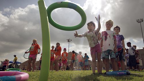 In this file photo, kids tries their hand at the ring toss as part of the festivities at a YMCA in Austin. RALPH BARRERA/ AMERICAN-STATESMAN
