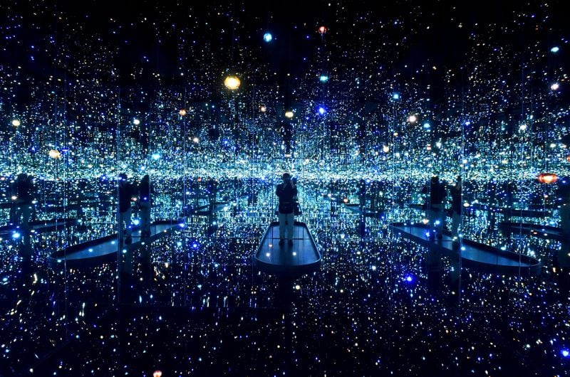 “The Souls of Millions of Light Years Away” is the first “Infinity Mirrors” room that visitors encounter when entering the exhibit “Yayoi Kusama: Infinity Mirrors” at the High Museum. The exhibition presents several of these rooms as well as sculptures, paintings, works on paper, film excerpts, archival ephemera, and additional large-scale installations that span from the early 1950s to the present day. HYOSUB SHIN / HSHIN@AJC.COM