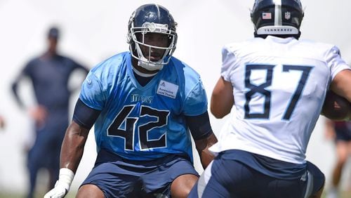 Tennessee Titans linebacker D'Andre Walker (42) runs a drill against tight end Geoff Swaim (87) during practice Sunday, Aug. 23, 2020, in Nashville. The former Georgia Bulldog was released and claimed by the Seattle Seahawks.