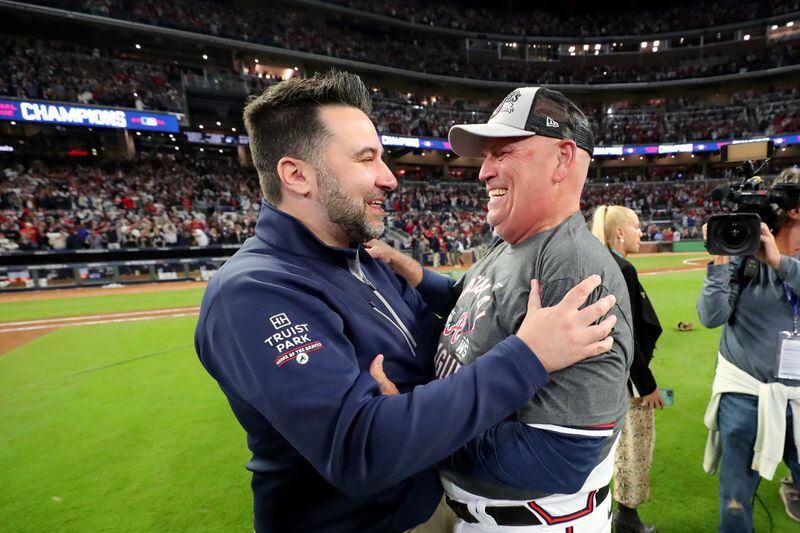Braves general manager Alex Anthopoulos, left, and manager Brian Snitker celebrate at Truist Park after their team clinched the National League Championship Series on Saturday to advance to the World Series.  (Curtis Compton / curtis.compton@ajc.com) 