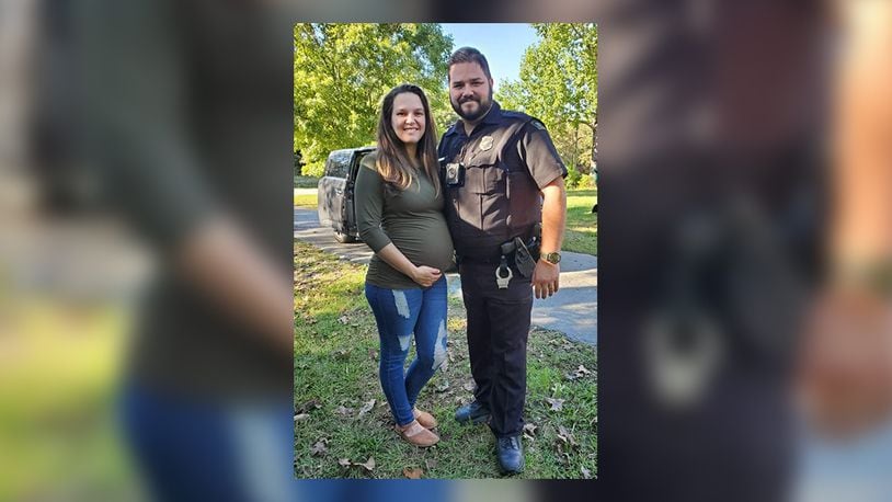 Chattahoochee Hills police officer Cpl. Joe Wells (right) with his wife, Lauren Wells. The couple helped save a man and woman stranded in their pickup truck suffering a medical emergency. (Courtesy photo)
