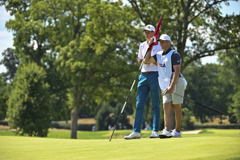 Christo Lamprecht and his caddie, Georgia Tech assistant coach Devin Stanton, wait to putt on hole 15 during the second round of stroke play at the 2022 U.S. Amateur at The Ridgewood Country Club in Paramus, N.J., on Tuesday. (Grant Halverson/USGA)