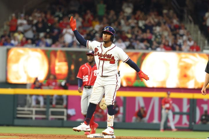 Braves second baseman Ozzie Albies reacts after connecting a two-run double in the second inning at Truist Park on Tuesday, April 12, 2022. Miguel Martinez/miguel.martinezjimenez@ajc.com