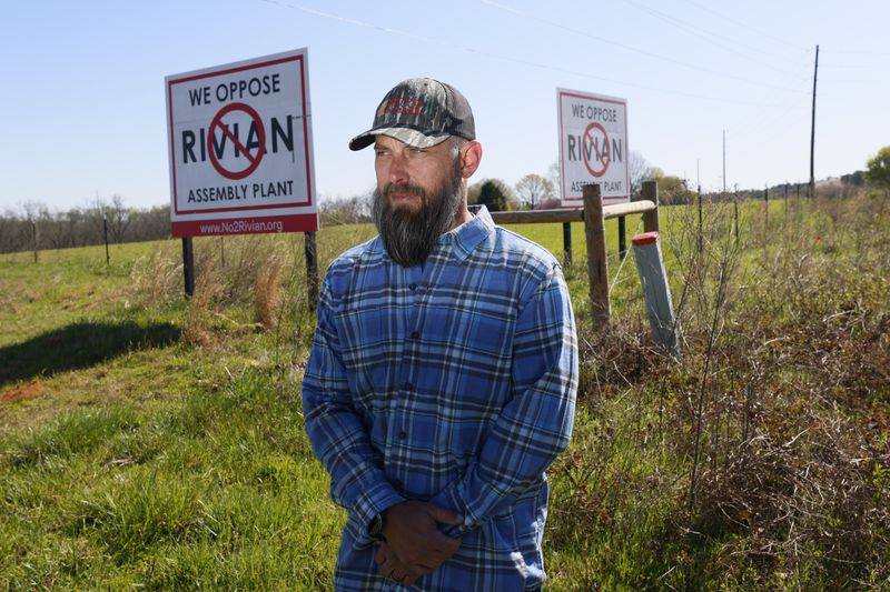 Morgan County Commissioner Blake McCormack poses for a photograph across from one of the roads leading to the Rivian construction manufacturing plant. Rivian announced its plans to halt the Georgia plant, which the newly elected official opposed when campaigning for the seat.
(Miguel Martinez /miguel.martinezjimenez@ajc.com)
