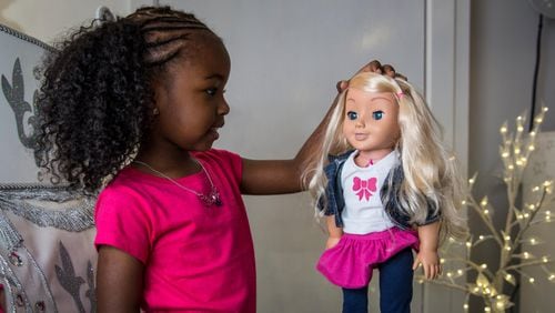 A little girl plays with a 'My Friend Cayla' doll at a store in London, England.  The doll, which uses Bluetooth technology to connect to Android and iOS devices, is on a warning list for potential toy hacking threats.