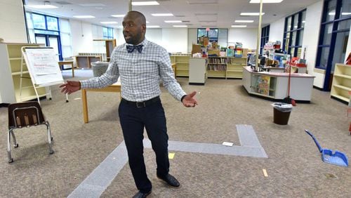 Davion Lewis, executive director, shows off the library of Latin College Preparatory School in East Point on Friday, June 29, 2018. Latin College Prep recently purchased the former Oak Knoll Elementary from Fulton County Schools. The school building has and will continue to house the schools that had been named Latin College Prep (a middle school) and Latin Grammar (an elementary school). Now that the charter school has ownership of the property, they will be doing some renovation work to it - including beefing up security, adding an outside gate, and doing some classroom refreshing. HYOSUB SHIN / HSHIN@AJC.COM