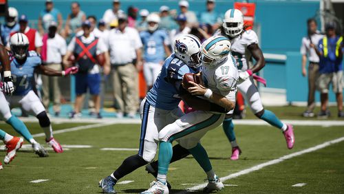 Miami Dolphins quarterback Ryan Tannehill (17) is sacked by Tennessee Titans outside linebacker Derrick Morgan (91) during the first half of an NFL football game, Sunday, Oct. 9, 2016, in Miami Gardens, Fla. (AP Photo/Wilfredo Lee)