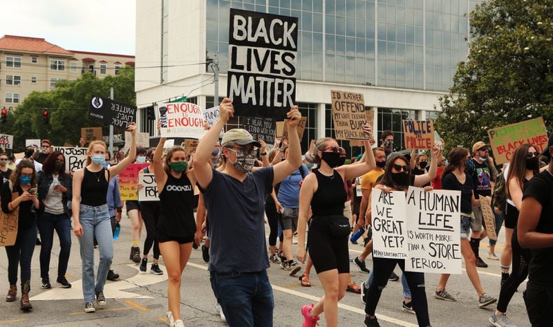 Peaceful protesters march around Decatur Square in support of the Black Lives Matter movement on Wednesday, June 3, 2020, in Decatur, Georgia. The protest was one of many throughout the country sparked by the death of Georgia Floyd, an unarmed black man in Minnesota. 