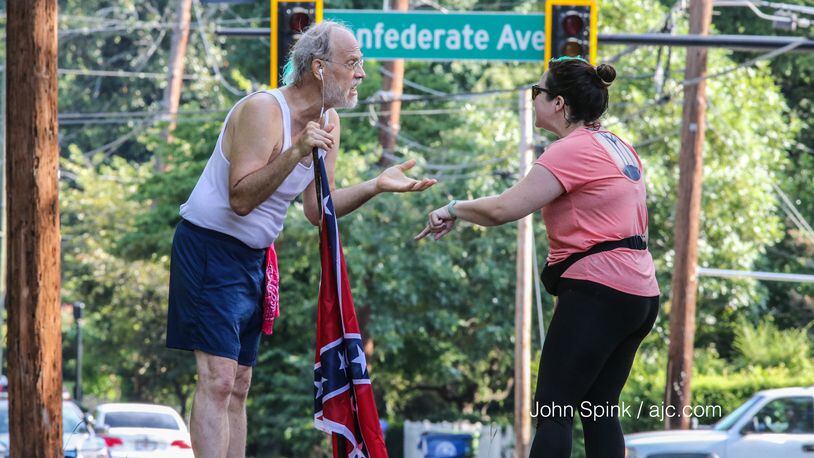 Alan Keck, left, debates Katie Kurumada on Boulevard in Grant Park. They are discussing the proposed name change of Confederate Avenue.