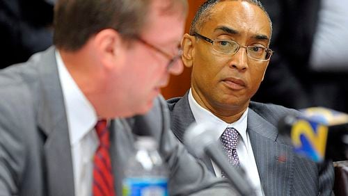 DeKalb County CEO Burrell Ellis, right, listens as attorney Craig Gillen responds to a 14-count indictment at a hearing to determine if the charges against Ellis will interfere with his job running the state's third-largest county, July 15, 2013.