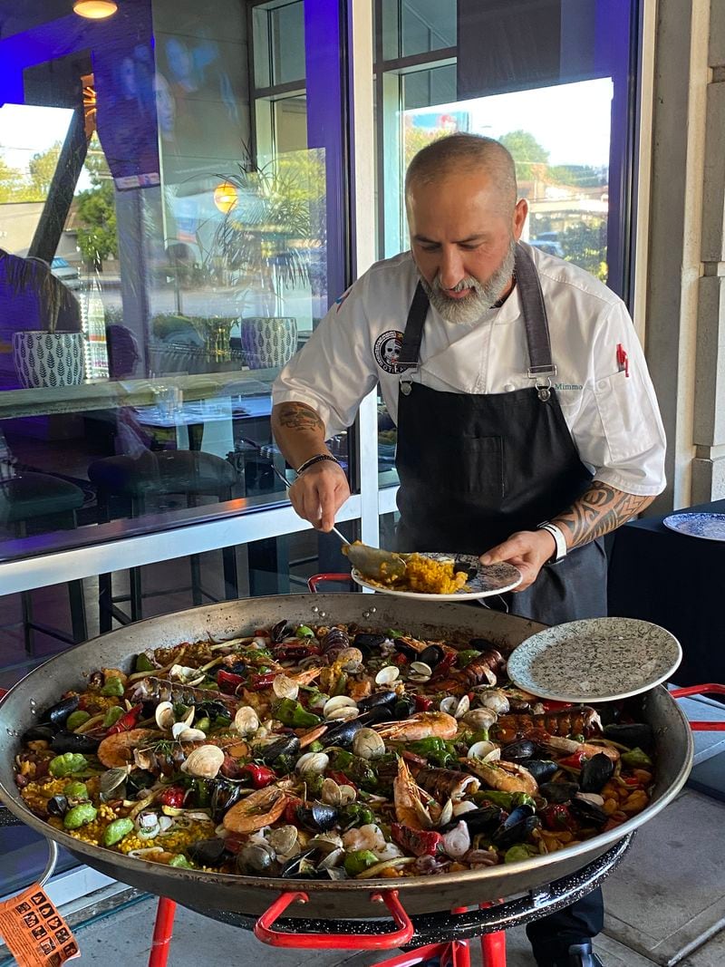 Chef Mimmo of Botica prepares paella on the restaurant's patio each Wednesday and serves it from 3-6 p.m.  He also makes it on the occasional Sunday and upon request. 
Ligaya Figueras / ligaya.figueras@ajc.com