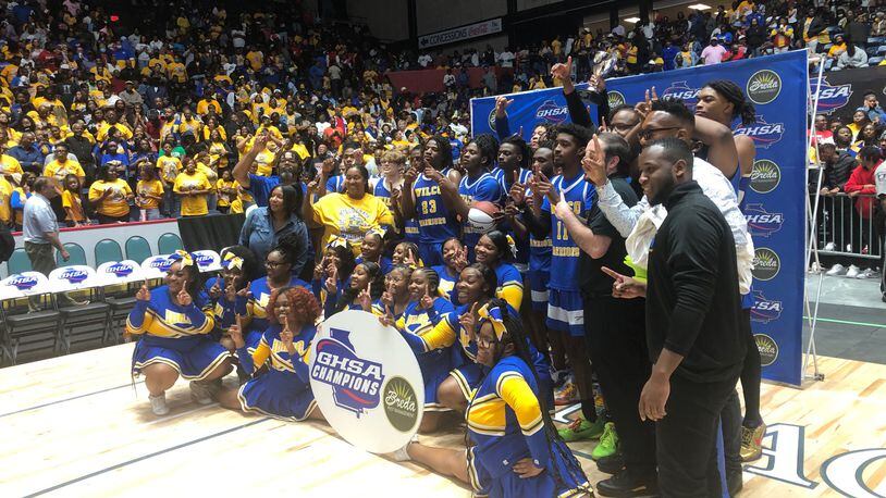 The Wilkinson County boys celebrate the school's 11th state championship after a 40-36 win over Charlton County at the Macon Coliseum, March 8, 2023.
