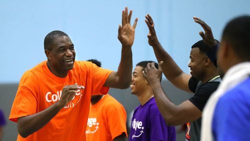 Dikembe high fives his teammates at the Breakthrough Atlanta Celebrity Basketball Game at the Lovett School in May 2017.