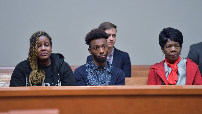Christopher Williams’ family members (from left) niece Arriyana Williams, nephew Xavier Williams and mother Cathy White react during a hearing  before Superior Court Judge Asha F. Jackson at DeKalb County Superior Court in Decatur on Thursday.